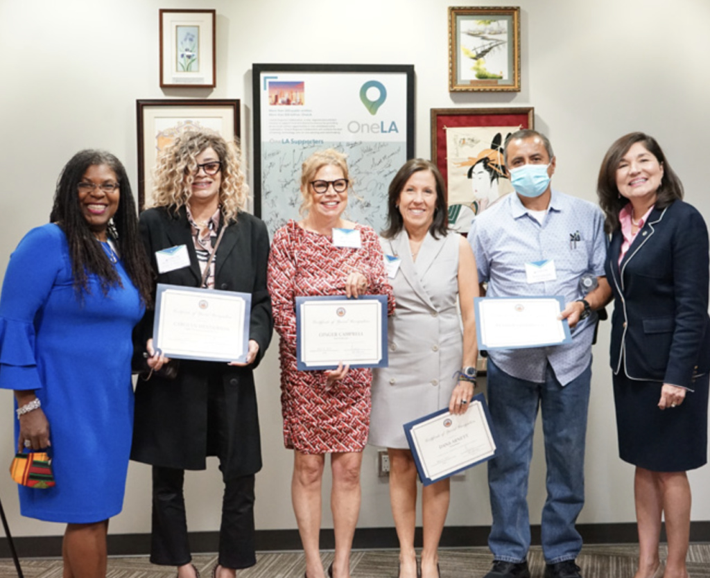 Dana C. Arnett receiving City of Los Angeles small business recognition alongside local business leaders and government officials