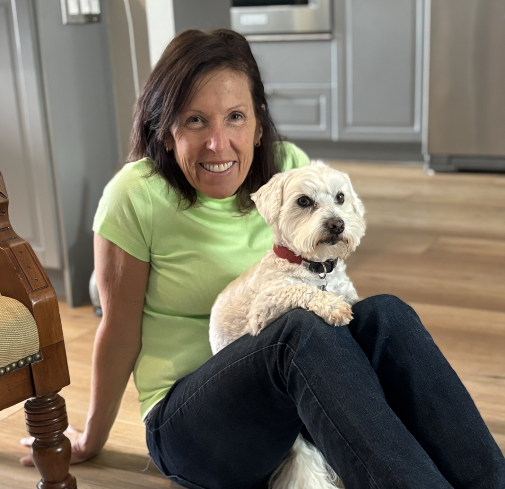 Dana C. Arnett with rescue dog Lucca Arnett-Hebert at home