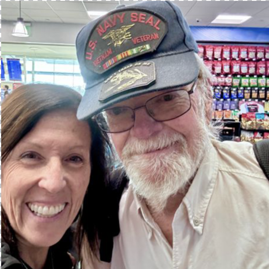 Dana C. Arnett with Vietnam veteran and former U.S. Navy SEAL during conversation at airport